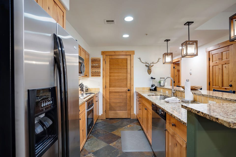 Create culinary memories in your fully equipped kitchen featuring granite countertops, stainless steel appliances, and rustic mountain charm.