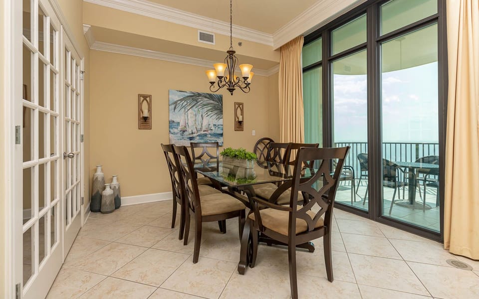 Savor family moments around the dining table, framed by expansive coastal views