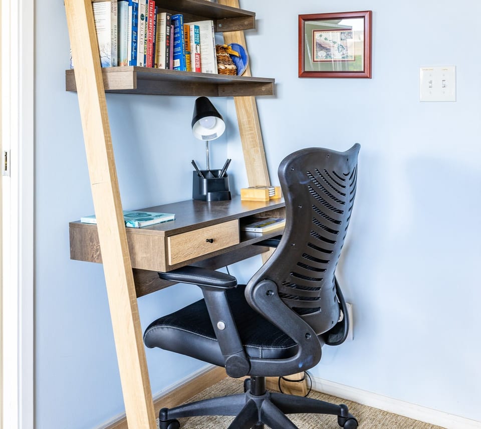 A thoughtfully designed workspace waits for you—settle into the ergonomic chair, open your laptop on the sleek desk, and enjoy the soft glow of the task lamp as you catch up on work or plan your next adventure.