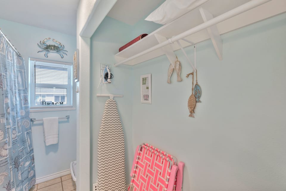 Your charming laundry nook features coastal-inspired decor and practical storage, making chores feel like a breeze with beach vibes.