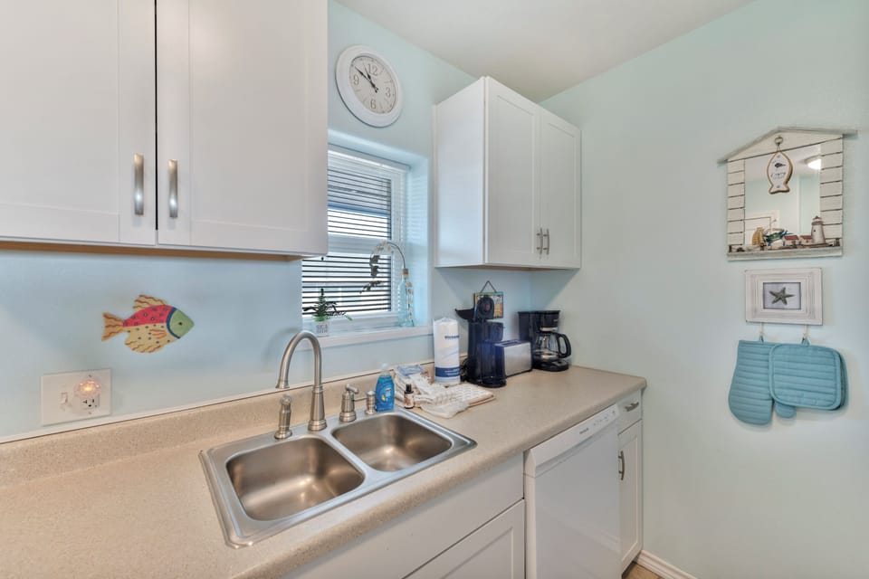 Your fully equipped kitchen features everything you need to prepare meals, with charming coastal touches and morning coffee essentials ready for you.