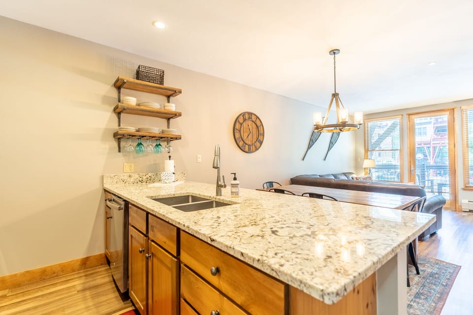 Your open kitchen flows seamlessly into the dining area, featuring granite countertops and rustic wood shelving for memorable meal prep moments.