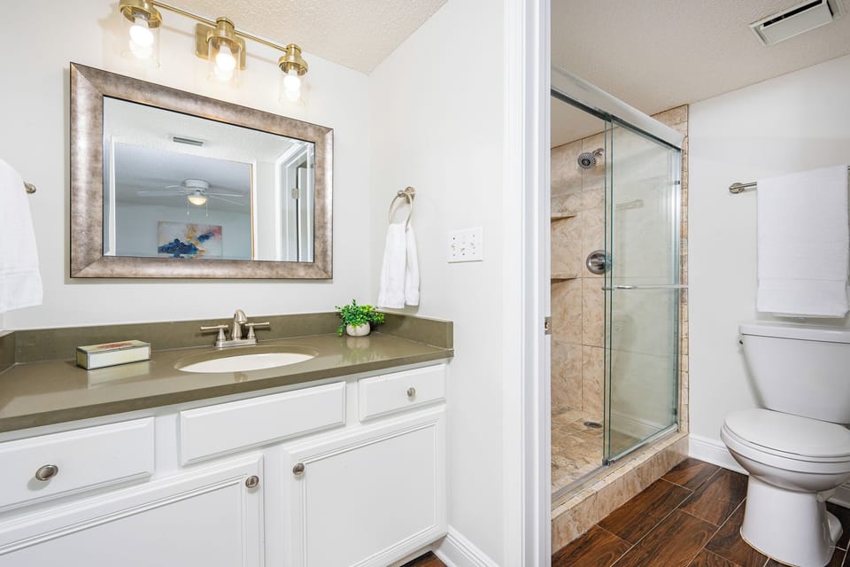 Refresh in the stylish master bath featuring a modern vanity, ample storage, and a walk-in shower