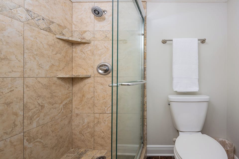 Stylish walk-in shower in the master bath featuring elegant tile work for a refreshing experience