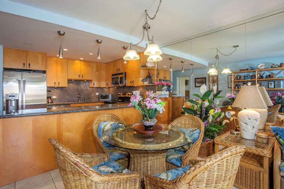 Bright, open-concept space featuring a fully equipped kitchen with modern appliances and a charming tropical-themed dining area where you'll gather for memorable meals.