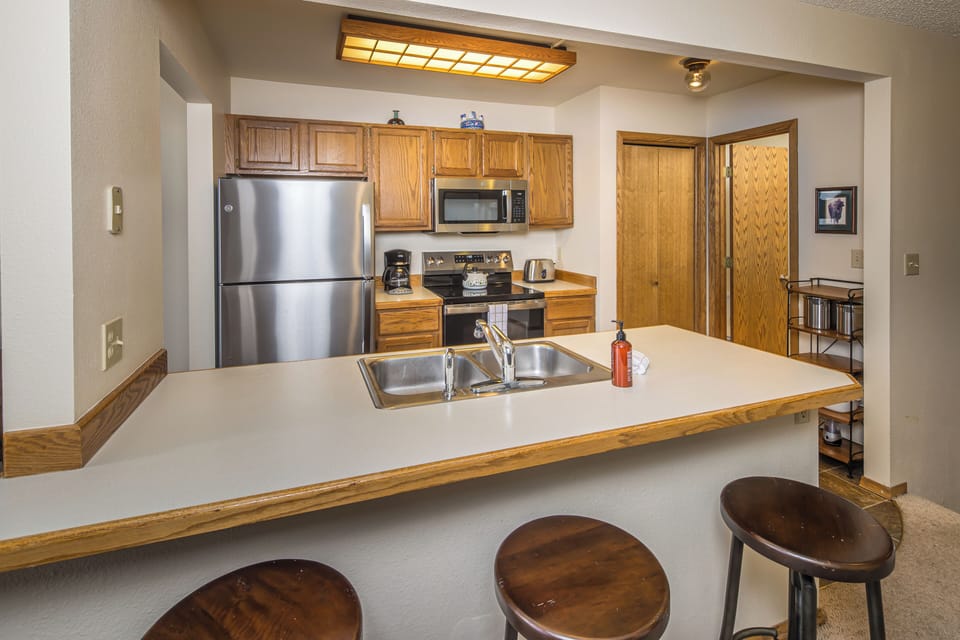 Enjoy a quick breakfast or cup of coffee at the bar with seating for 3 | Main Level