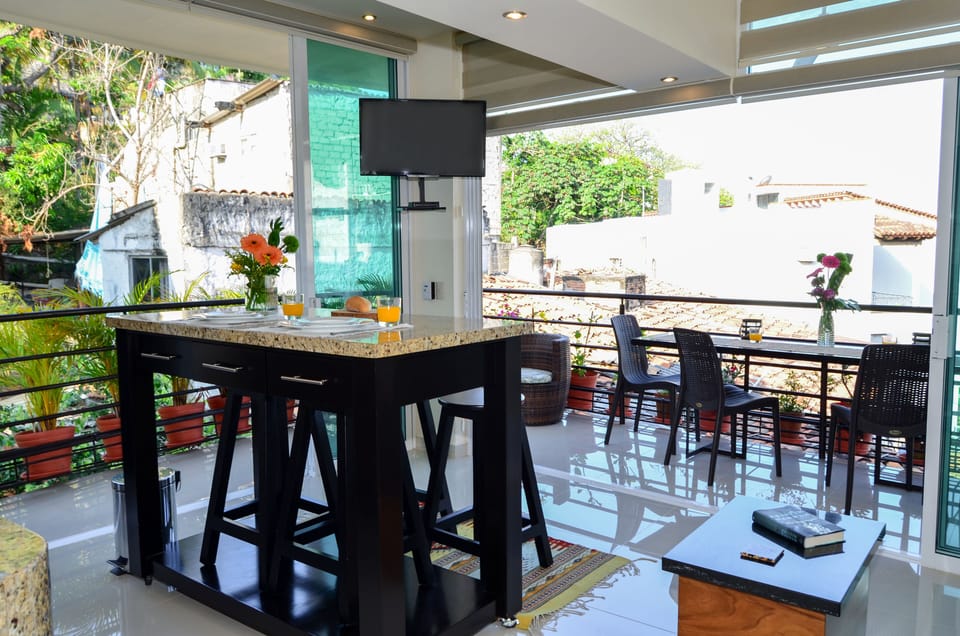 Kitchen, bar and living area opens completely to balconies for open-air living!