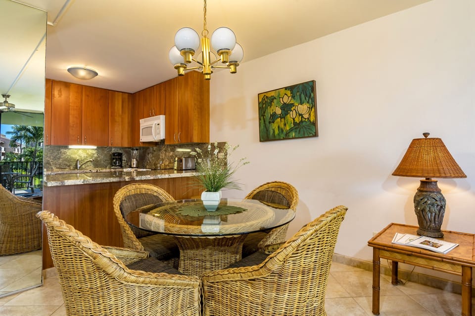 Gather around this inviting dining space where island-inspired decor meets comfort. You'll love sharing meals beneath the warm chandelier, surrounded by tropical artwork and the ease of your fully-equipped kitchen just steps away.