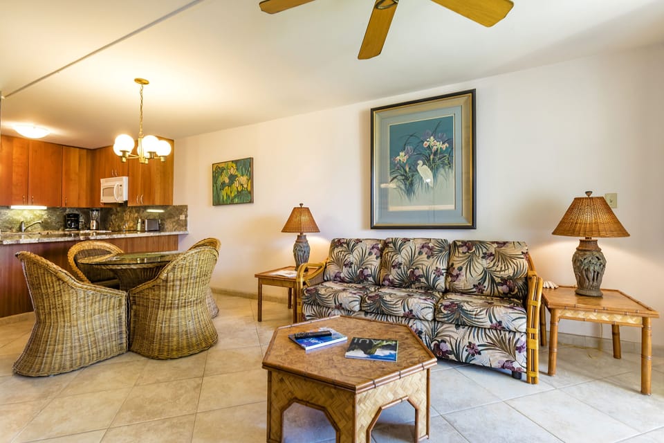 Unwind in your bright, tropical-themed living space, where island-inspired décor and comfortable seating invite relaxation. The open-concept layout seamlessly connects to a fully-equipped kitchen, creating a welcoming home base for your getaway.
