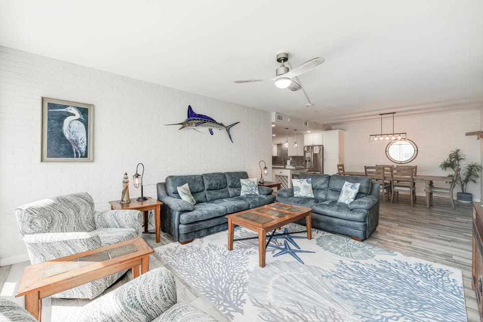 Sink into coastal comfort in your spacious living room, where nautical touches and plush seating create the perfect retreat after beach days.