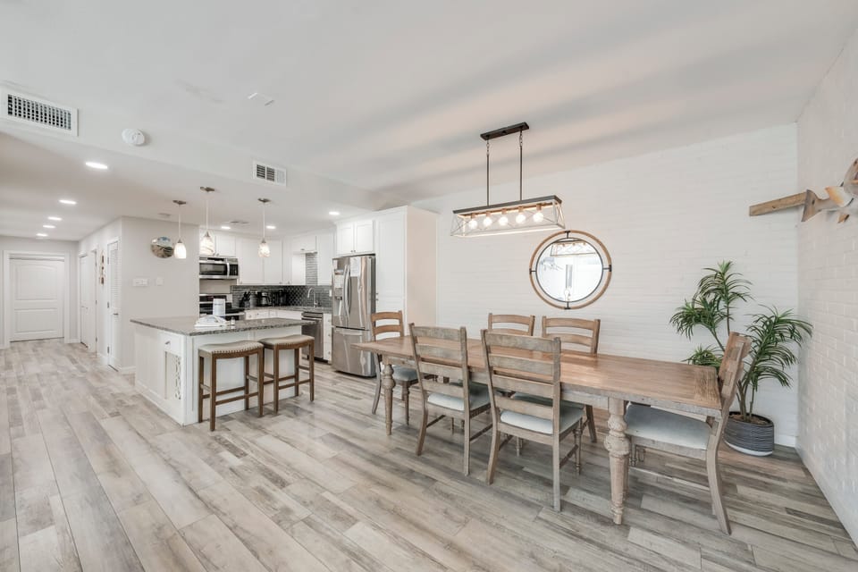 Your open-concept kitchen and dining space blends modern convenience with coastal charm, perfect for family meals and entertaining.