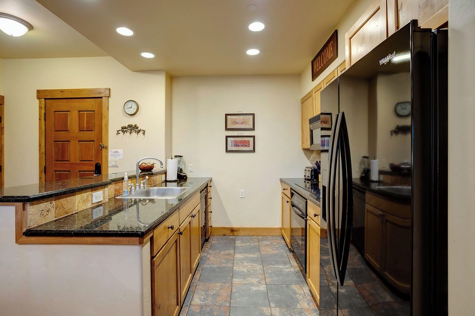 Your spacious kitchen awaits with granite counters, stainless steel appliances, and everything you need to create memorable meals during your stay.