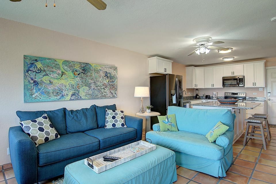 Relax in coastal comfort with ocean-inspired blues and your fully equipped kitchen ready for memorable meals.