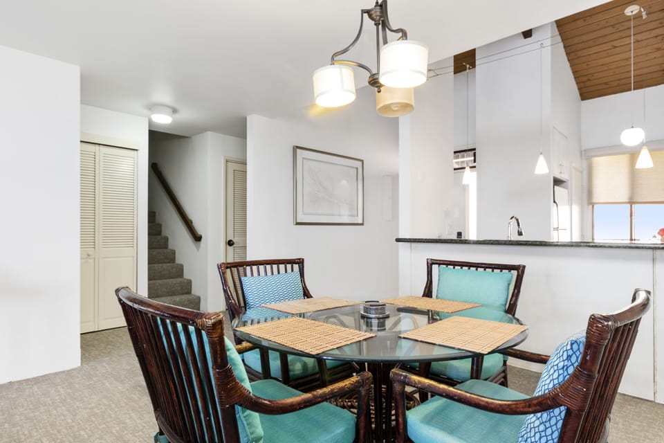Gather around your elegant dining table for meals and conversation beneath the warm glow of classic lighting, with the open kitchen just steps away and natural light streaming through the windows.