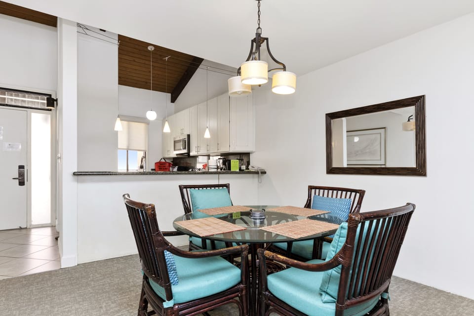 Gather around this inviting dining space where bright turquoise cushions and warm wood tones create the perfect spot for your morning coffee or evening meals together.