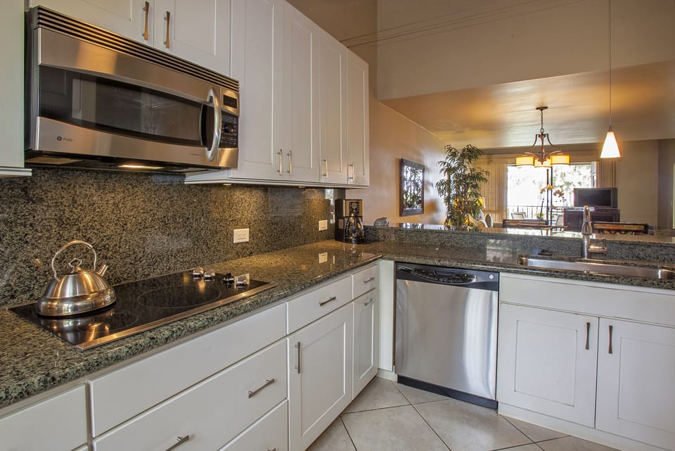 Your fully equipped kitchen invites you to prepare meals with ease, featuring granite counters, stainless steel appliances, and a welcoming open layout that flows into the living space.