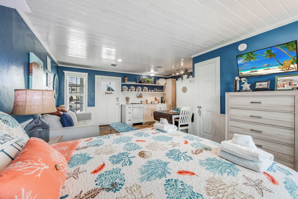 Drift off in this charming beach-themed room with coral reef bedding, ocean-blue walls, and your own kitchenette for morning coffee.