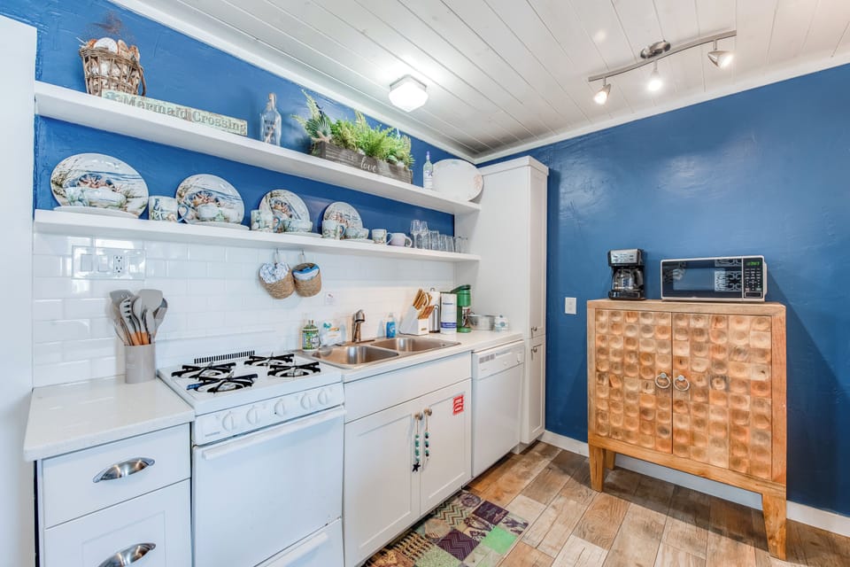 Your charming blue kitchen awaits with vintage dishes, modern appliances, and all the essentials for cooking memorable meals during your stay.
