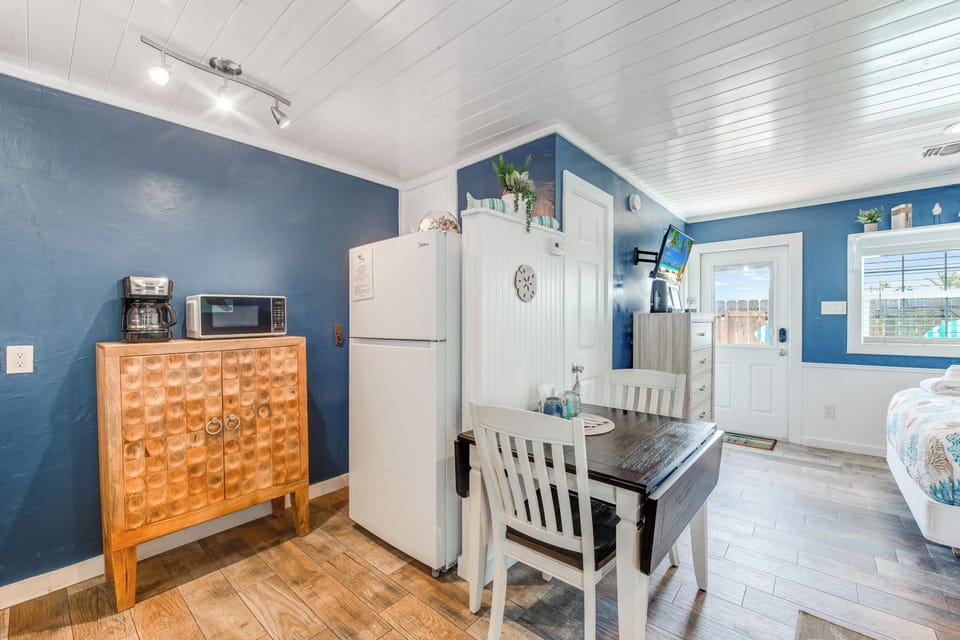 Your charming kitchen nook features everything you need: full-size fridge, microwave, and cozy dining table where you can enjoy morning coffee.