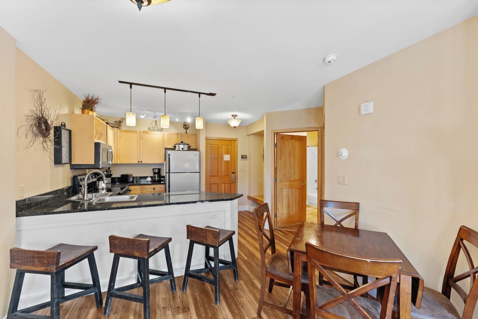 Your open kitchen features modern appliances and granite counters, perfect for preparing meals together with breakfast bar seating.