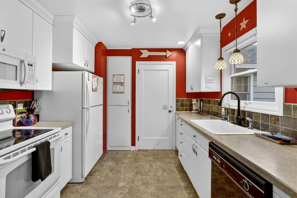 Prepare meals in the bright, fully stocked kitchen with all appliances and utensils. Perfect for cooking, family meals, and gathering with loved ones.