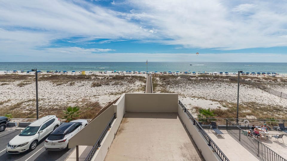 This inviting view showcases a beachside pathway leading to the sandy shore, perfect for relaxing days by the water