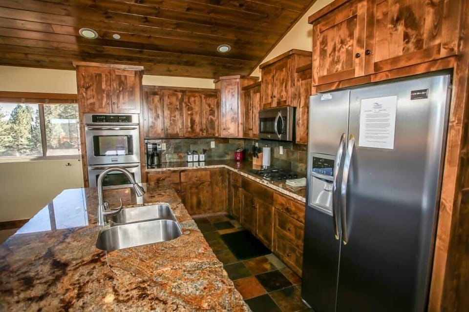 Beautiful stainless steal fridge and wood cabinets.