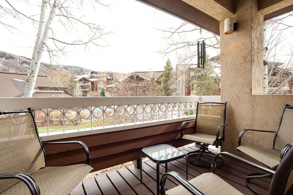 Relax on your private balcony with mountain views, comfortable seating, and peaceful neighborhood surroundings perfect for morning coffee or evening unwinding.