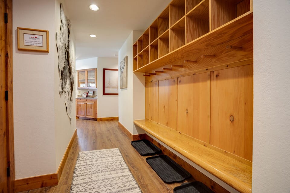 Your custom mudroom welcomes you home with handcrafted wooden cubbies and built-in bench seating for easy gear storage.