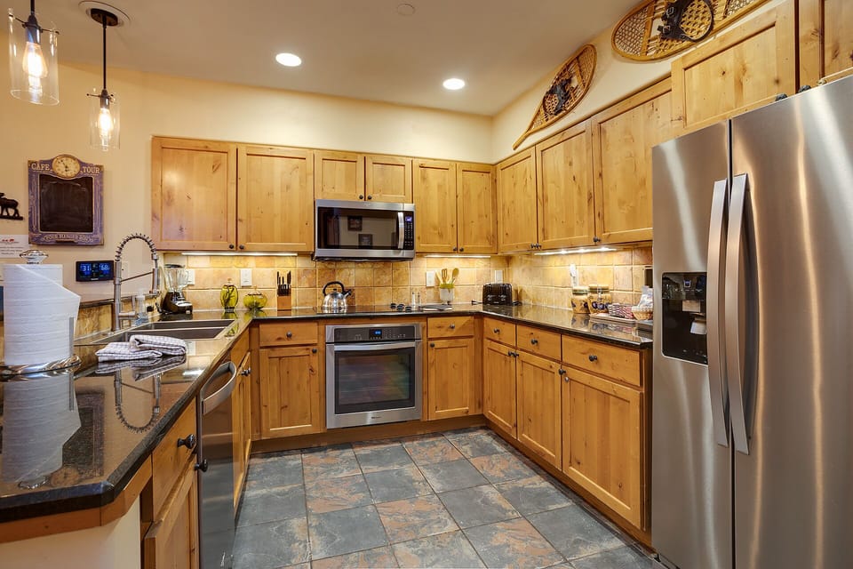 Your fully equipped kitchen features granite counters, stainless appliances, and warm wood cabinetry for all your culinary adventures.