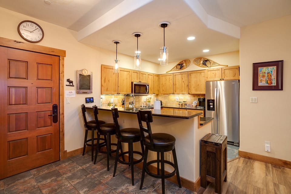 Gather around your spacious kitchen island for morning coffee and meal prep in this beautifully appointed space with warm wood finishes.