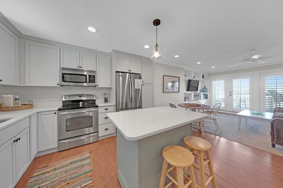 This kitchen is well equipped with a full-size refrigerator, oven, stovetop, microwave, dishwasher, and all the cookware and dishes you'll need to prepare and enjoy a meal.