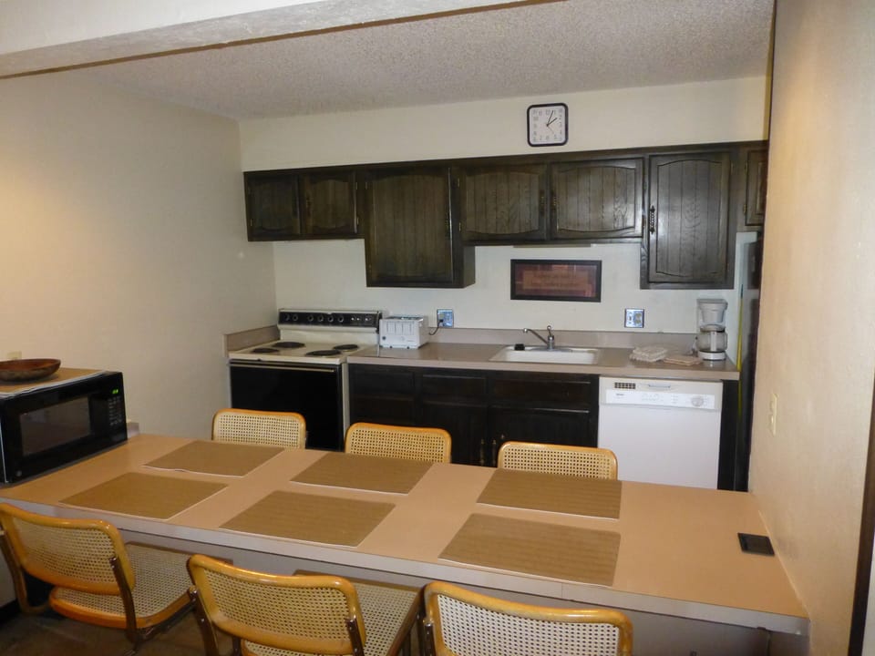 Ample seating for 6, very dated cabinets, counters, appliances, newer dishwasher