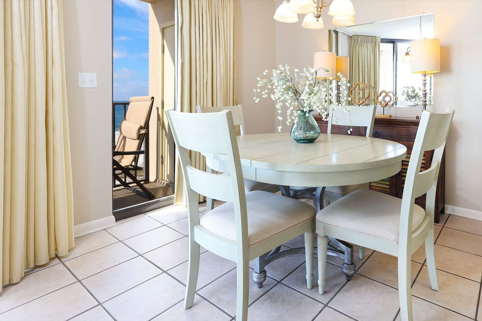 Gather around the round dining table and enjoy meals with a view of the beach