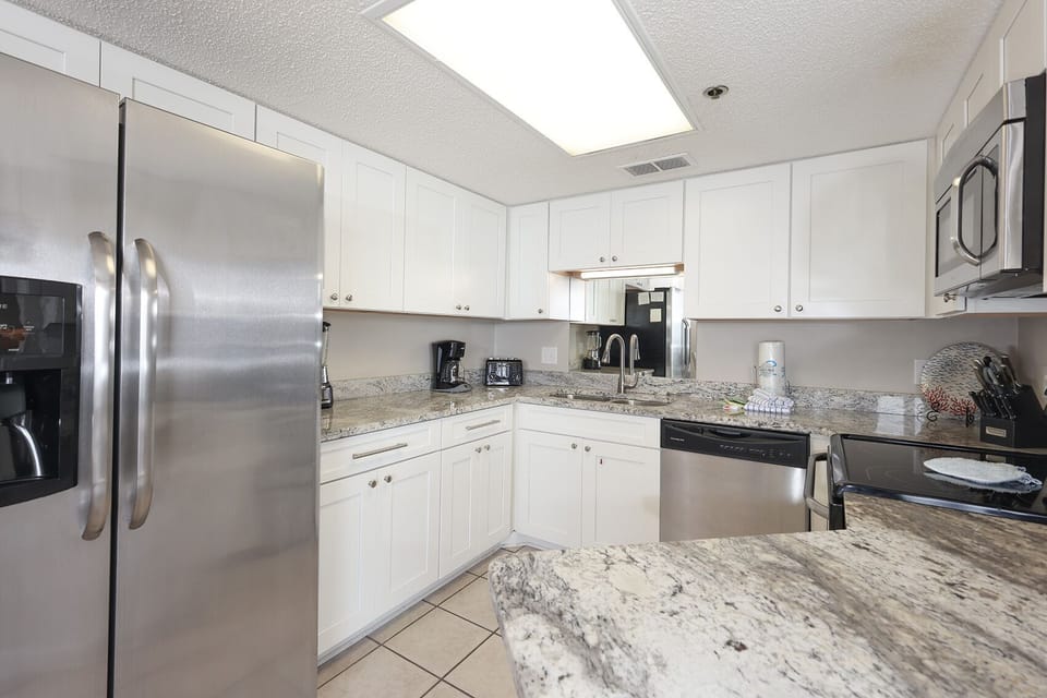 Inviting kitchen with stainless appliances and elegant granite countertops for culinary enjoyment