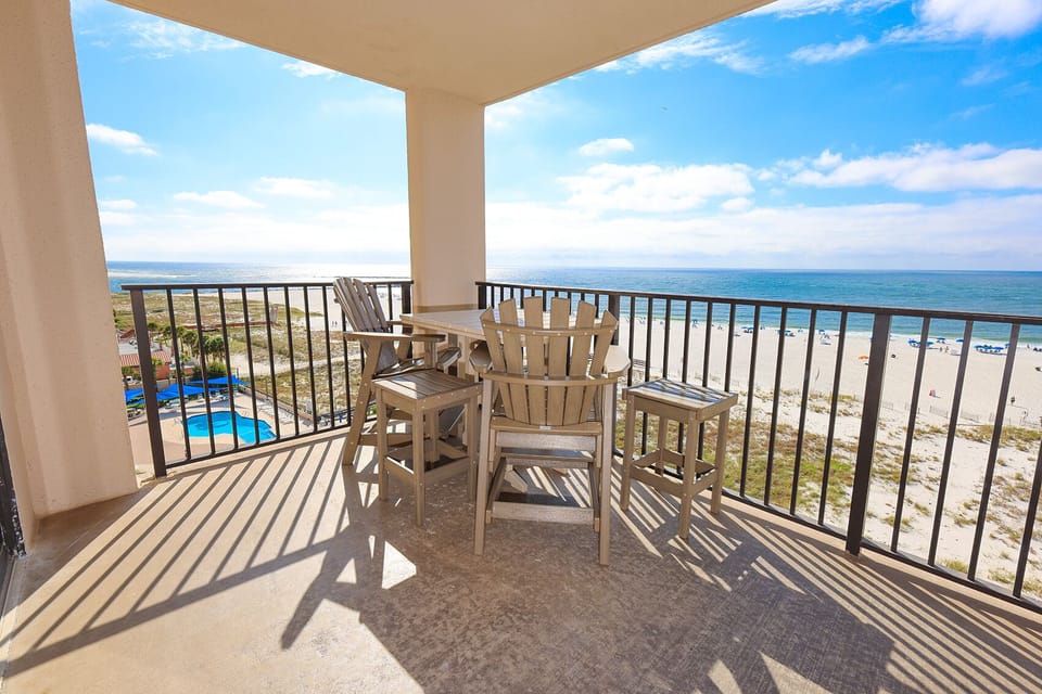 Relax on the balcony enjoying views of the beach and gentle waves while sipping your favorite drink