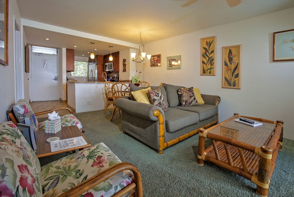 Unwind in your inviting living space featuring comfortable tropical seating, island-inspired decor, and an open flow to your fully equipped kitchen—perfect for relaxing after island adventures.
