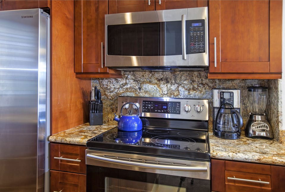 Your fully equipped kitchen features stainless steel appliances, granite countertops, and everything you need to prepare meals—from coffee maker to microwave to stove.