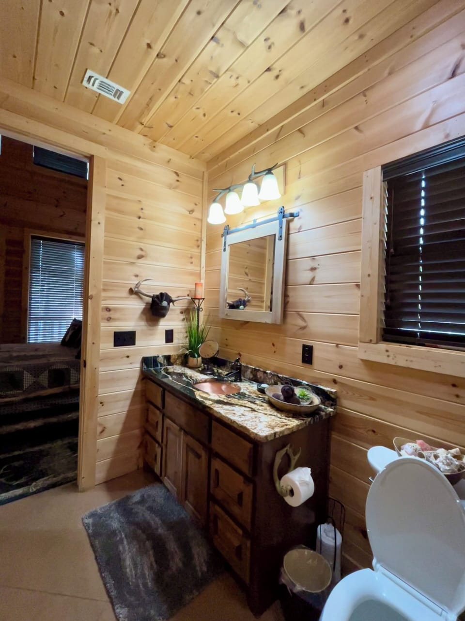 Primary full bathroom with large three head shower.