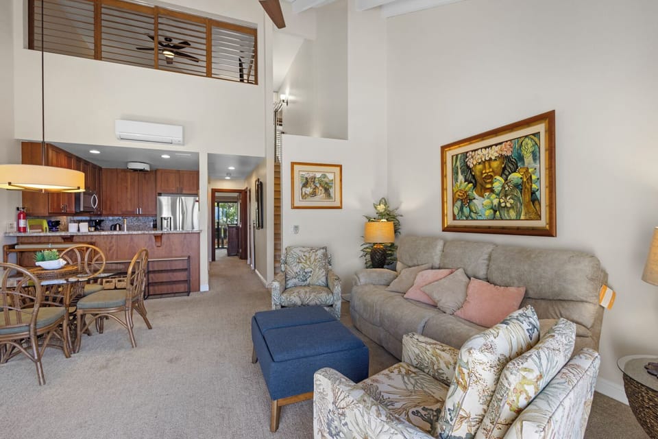 Settle into your spacious retreat with soaring ceilings and tropical-inspired art. Relax on the plush seating or gather at the dining table, with your kitchen just steps away.