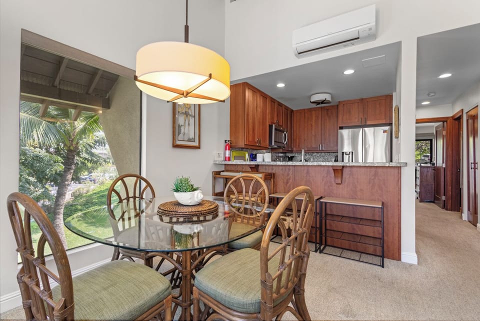 Enjoy meals with garden views at your private dining table. The well-equipped kitchen features modern appliances and warm wood cabinetry, making it easy to prepare your favorite dishes.