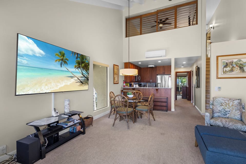 Spacious open-concept living space with soaring ceilings, cozy dining for four, and a fully equipped kitchen—perfect for unwinding after your island adventures.
