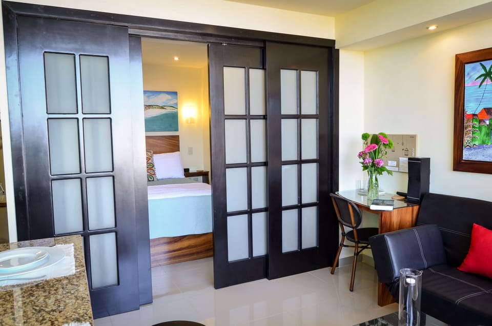 Tropical parota wood work station, french doors partially open to bedroom.