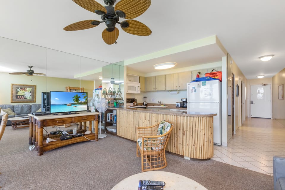 Relax in your tropical-inspired open-concept space with bamboo-style kitchen, comfortable seating, and bright coastal vibes. Ceiling fans keep you cool while you unwind and enjoy your island getaway.