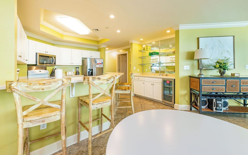 Rustic wooden stools line the bar where you pour cool drinks while sharing stories in your vacation rental