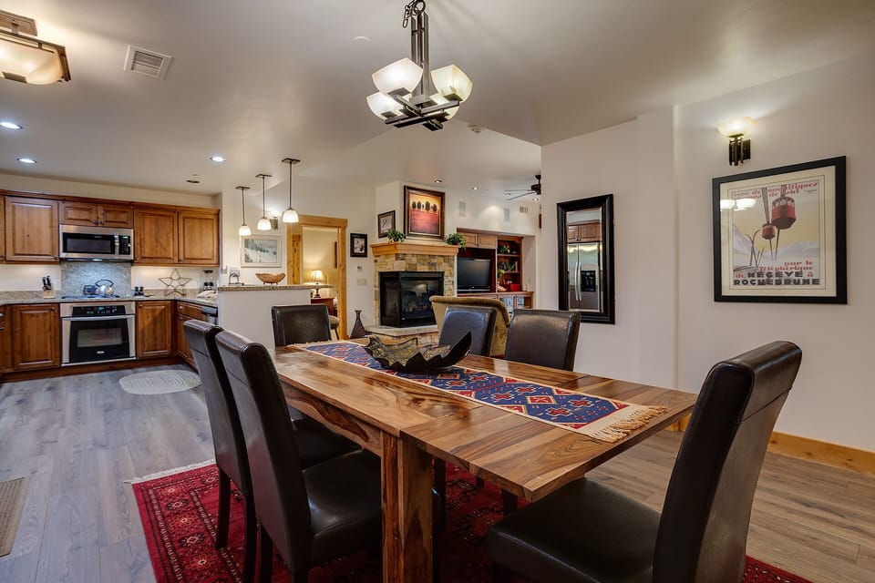 Gather around this stunning wood dining table where memorable meals and conversations await in your open-concept haven.