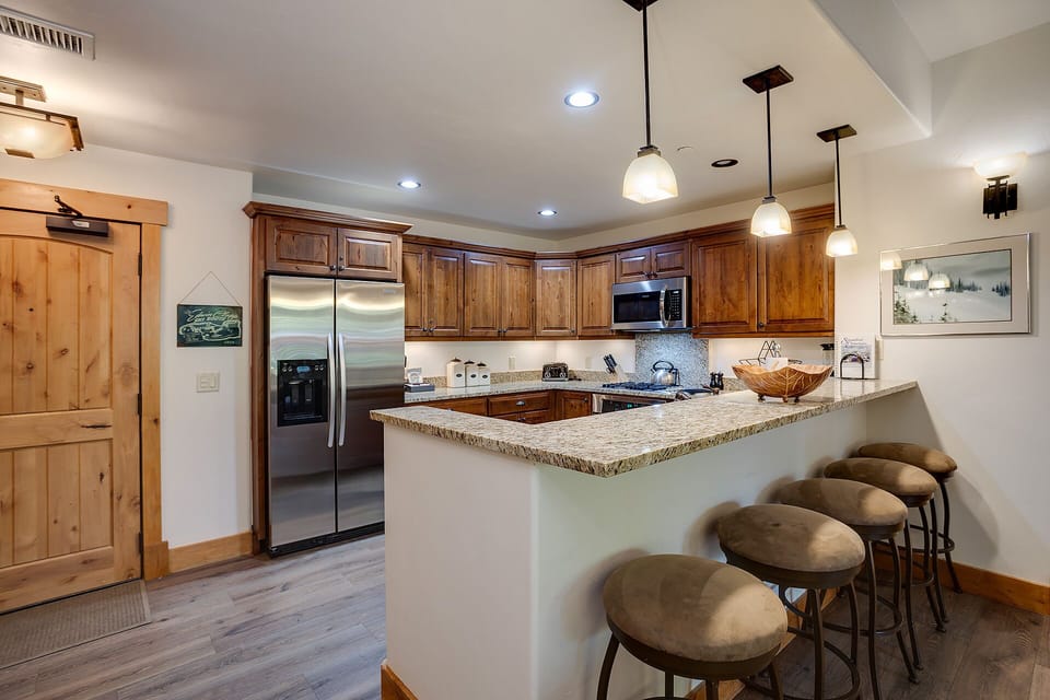 Your fully equipped kitchen features granite countertops, stainless steel appliances, and a breakfast bar where you can savor morning coffee.