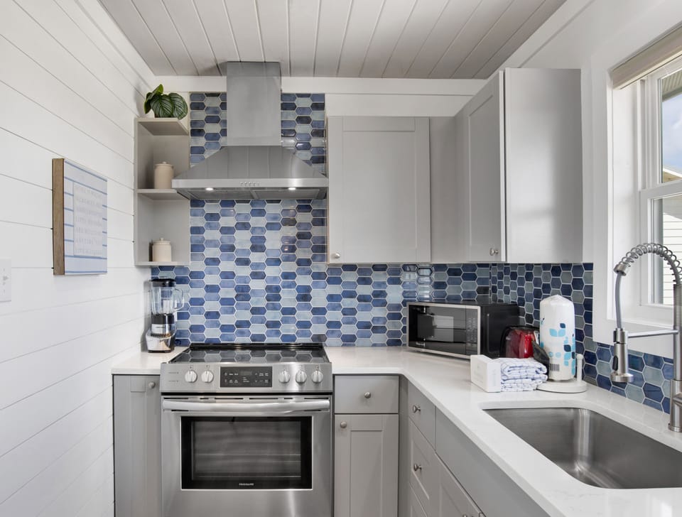 Updated kitchen offers stainless appliances and stone counters