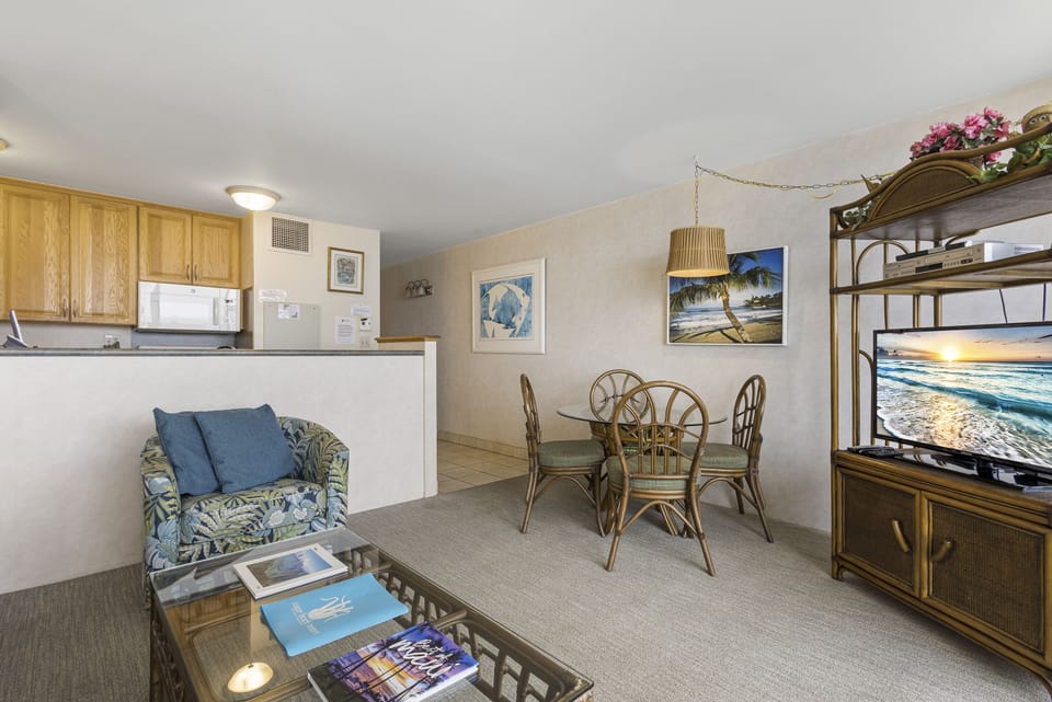 Your coastal-themed retreat combines a fully-equipped kitchen, cozy dining nook, and living area with tropical décor—perfect for unwinding after a day exploring paradise.