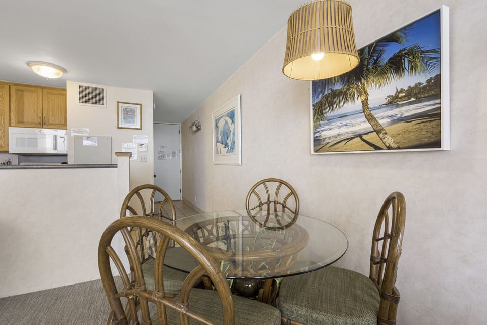 Gather around this inviting dining space where meals become memories. The coastal artwork and warm lighting create the perfect ambiance for your island getaway.